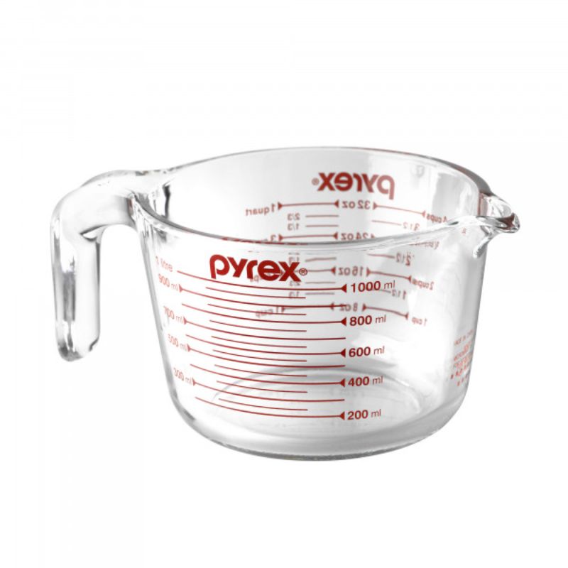 Pyrex 4 Cup Measuring Jug in durable borosilicate glass with clear red measurement markers and ergonomic handle for easy pouring.