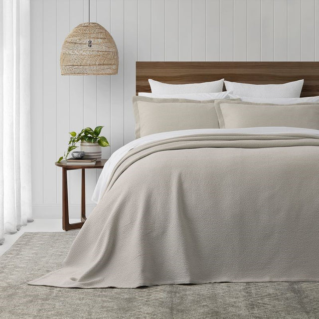 Ecru stonewashed bedspread set by BAKSANA, featuring textured stitching and mitred corners, ideal for a tidy bedroom look.
