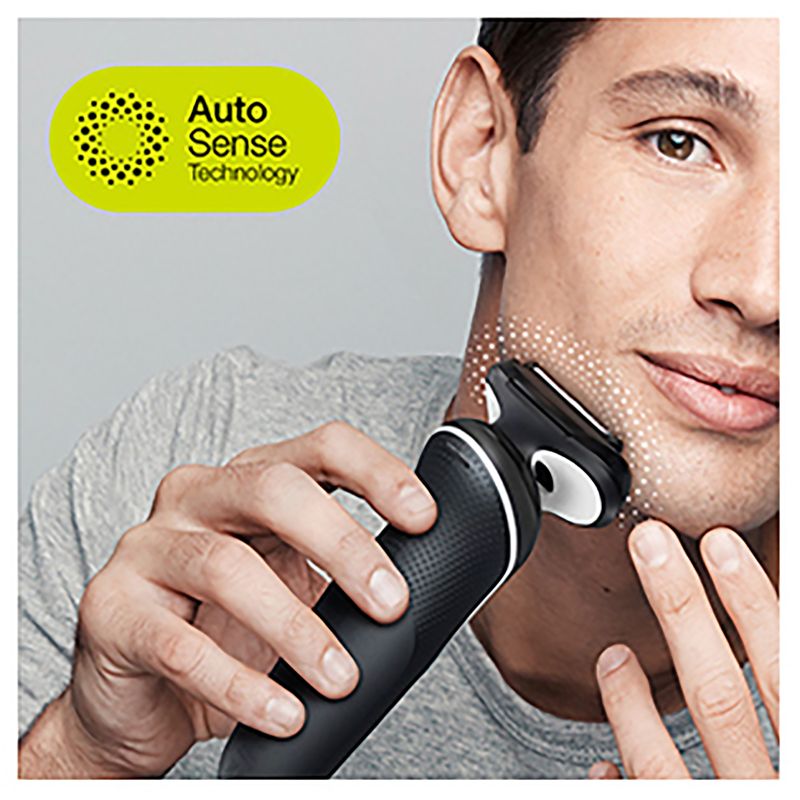 Braun Wet & Dry shaver with charging stand, including beard trimmer and body groomer attachments for versatile grooming.