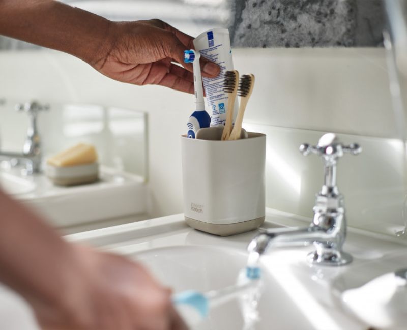 Joseph Joseph EasyStore Toothbrush Caddy in Ecru, featuring organized sections for toothbrushes and toothpaste, ventilated base, and non-slip feet.