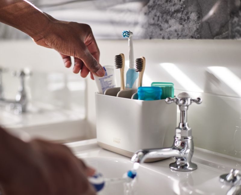 Joseph Joseph EasyStore large toothbrush caddy in ecru with compartments for organized dental care essentials.