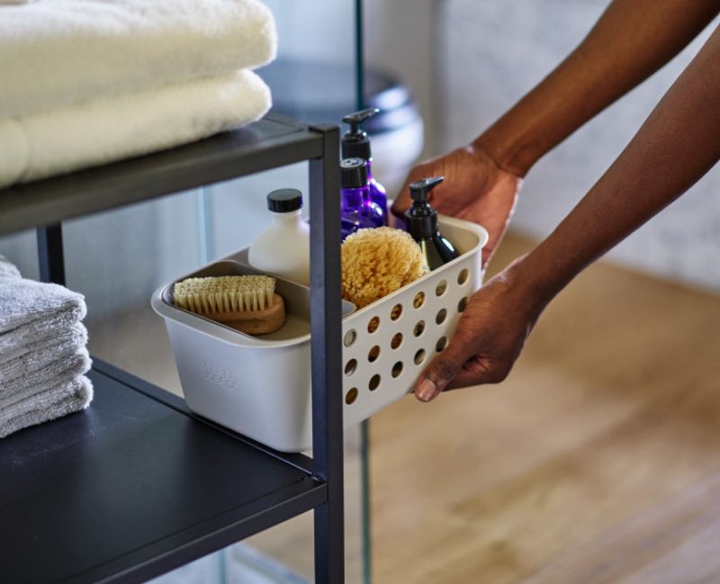 Joseph Joseph EasyStore Basket for bathroom, featuring ventilated sides, moveable tray, and ideal for organizing grooming essentials.