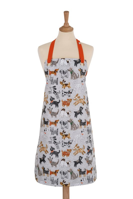 Colorful oilcloth apron featuring playful illustrated dogs, ideal for stylish cooking and eco-conscious kitchen use.