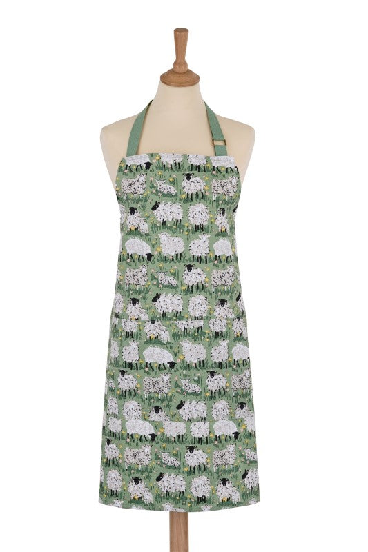 Cotton apron featuring whimsical hand-illustrated sheep on a green countryside backdrop, sustainable and adjustable for comfort.
