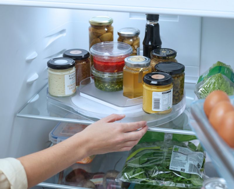 Joseph Joseph FridgeStore Rotating Organiser with 360-degree base, tiered platform, and non-slip design for efficient fridge storage.