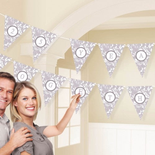 Customizable silver pennant banner kit includes 24 pennants, letters, and ribbon for festive decorations.