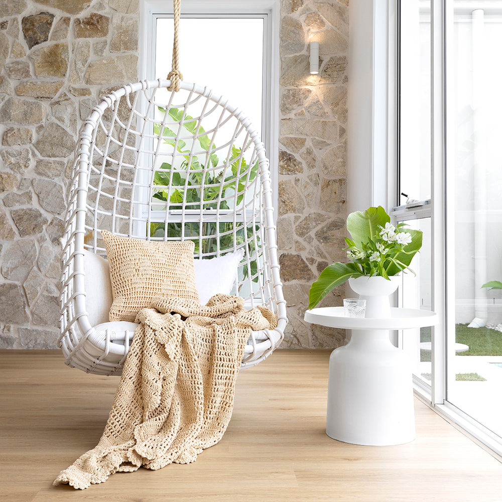 Hand-crocheted custard throw from Bambury with floral motif, perfect for cozy decor and layering on sofa or bed.