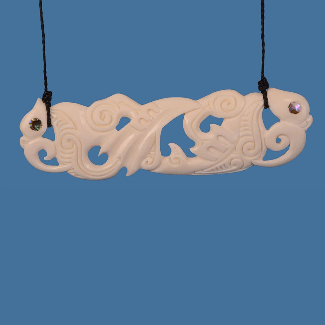 Handcrafted Bone Double Manaia XL Necklace featuring intricate designs, symbolizing protection and harmony on a braided cord.
