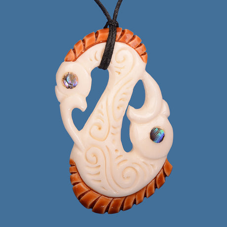 Handcrafted Bone Double Head Manaia Pendant featuring intricate carvings and adjustable black wax cord for a unique style.