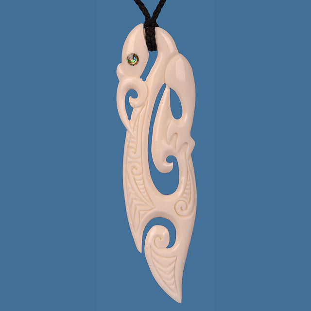 XL Bone Manaia Pendant, hand-carved from beef bone, symbolizing protection and luck, strung on an adjustable black cord.