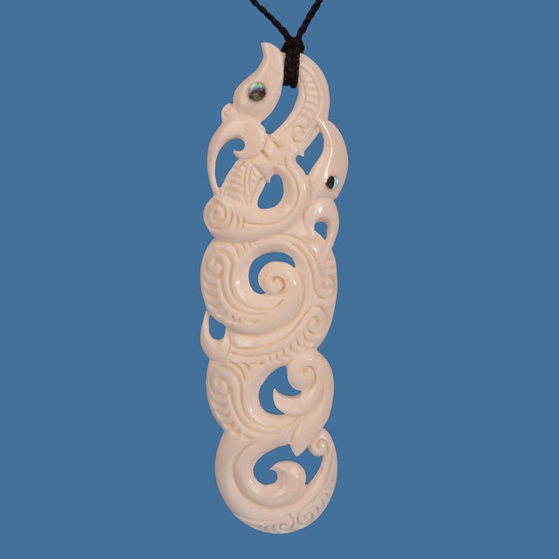 XL Bone Manaia pendant featuring intricate whale tail carvings, 340mm wide, symbolizing heritage and protection.