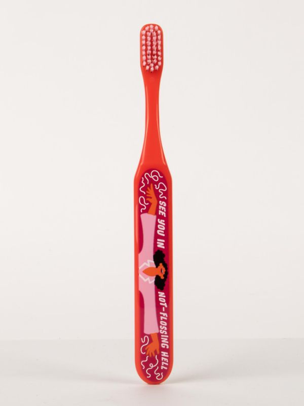 Humorous Blue Q toothbrush with soft bristles and wide handle, perfect for gentle brushing and a fun dental care routine.