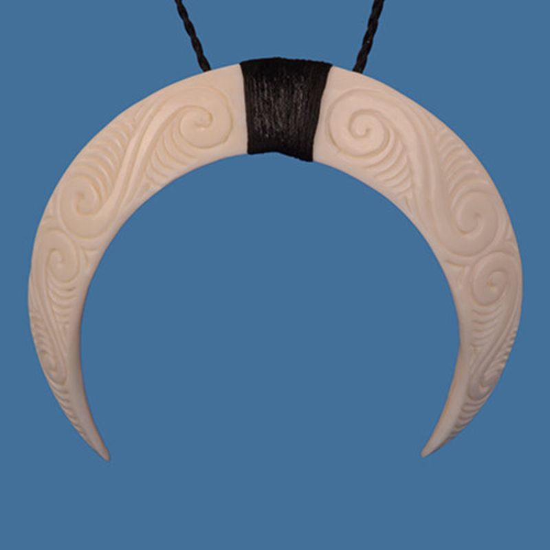 Hand-carved Tusk Arc Pendant on braided wax cord, showcasing natural elegance and intricate patterns, adjustable for perfect fit.