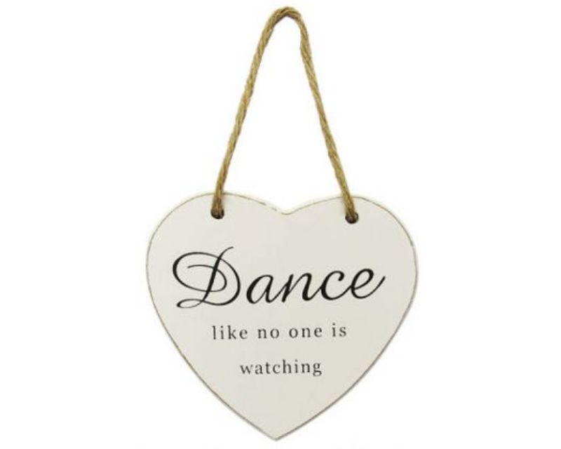 White heart-shaped hanger with inspirational words on a rope, perfect for decor in dance studios or children's rooms.