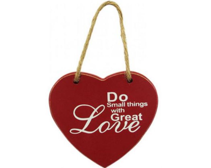 Heart-shaped red wall decor with heartfelt words, perfect for adding love to any room.