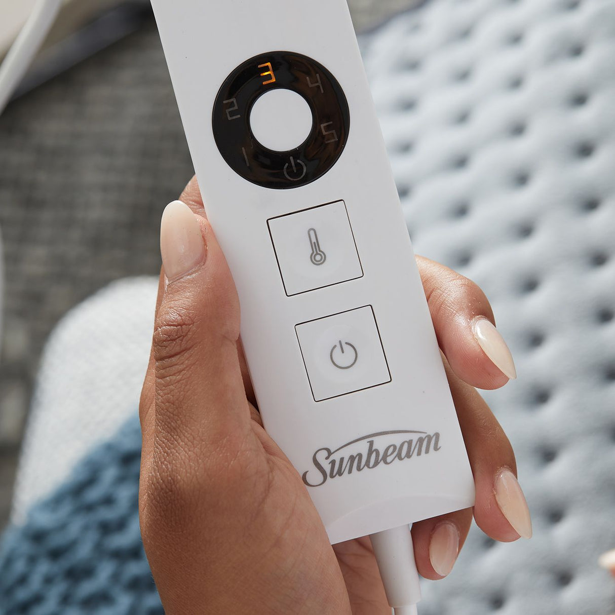 Sunbeam HPM5000 heating pad in grey, providing soothing warmth for sore muscles with adjustable heat settings and safety features.