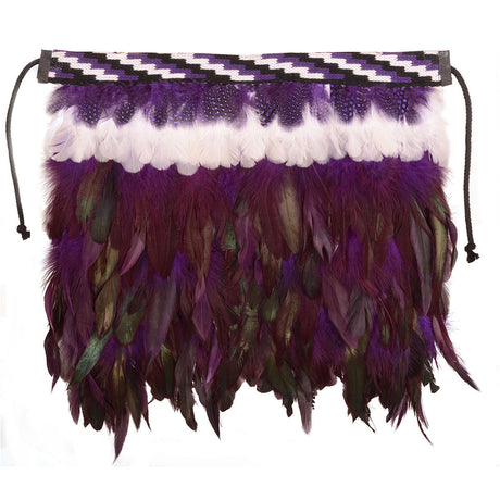 Purple Korowai christening cloak adorned with feathers and Poutama design, symbolizing growth and warmth for special occasions.