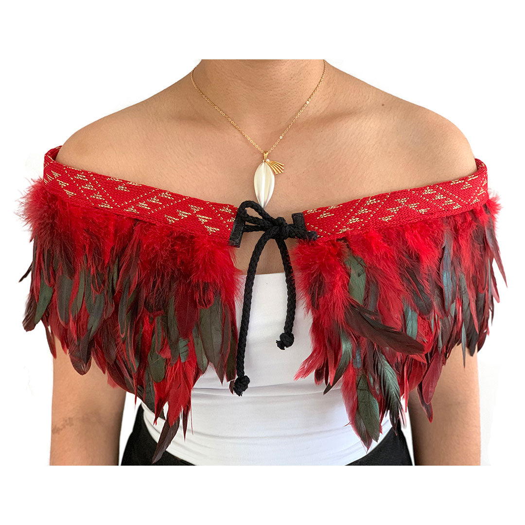 Elegant red Korowai Cape with taniko trim, handcrafted from ethically sourced feathers, perfect for special occasions.