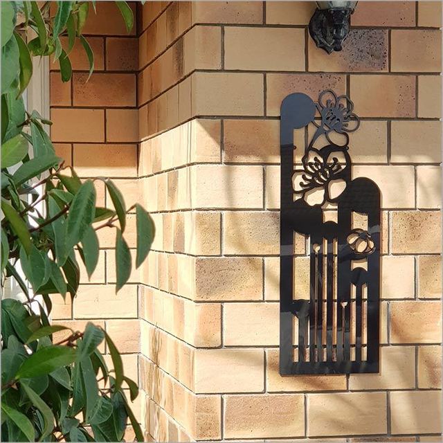 Large Koru Manuka wall art in black, 790mm, showcasing Kiwiana design, ideal for indoor and outdoor decoration.