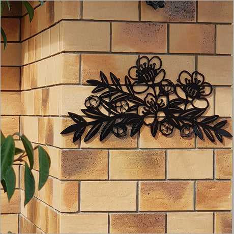 Large black Manuka branch wall art made from durable ACM, 645mm x 345mm, ideal for indoor or outdoor Kiwiana decor.
