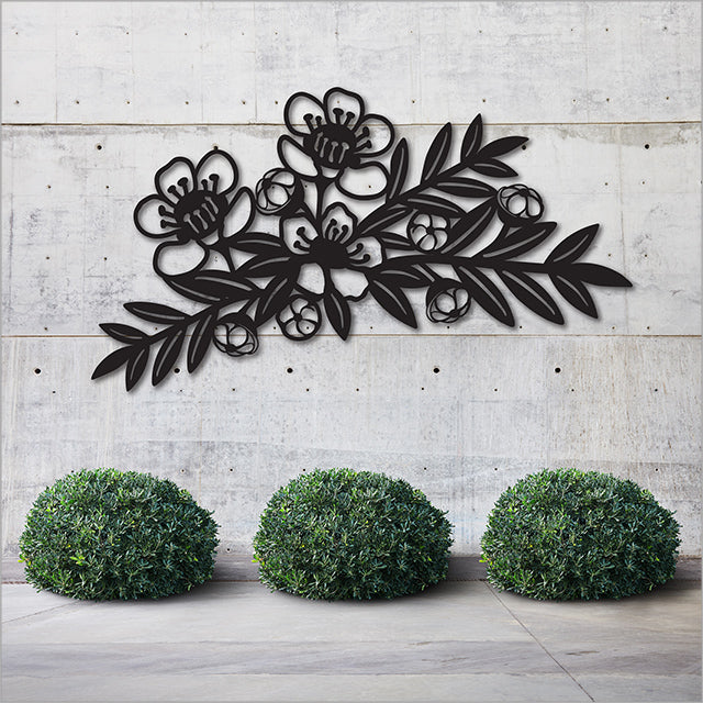Large black Manuka branch wall art, 645mm x 345mm, durable ACM, ideal for indoor/outdoor Kiwiana decor.