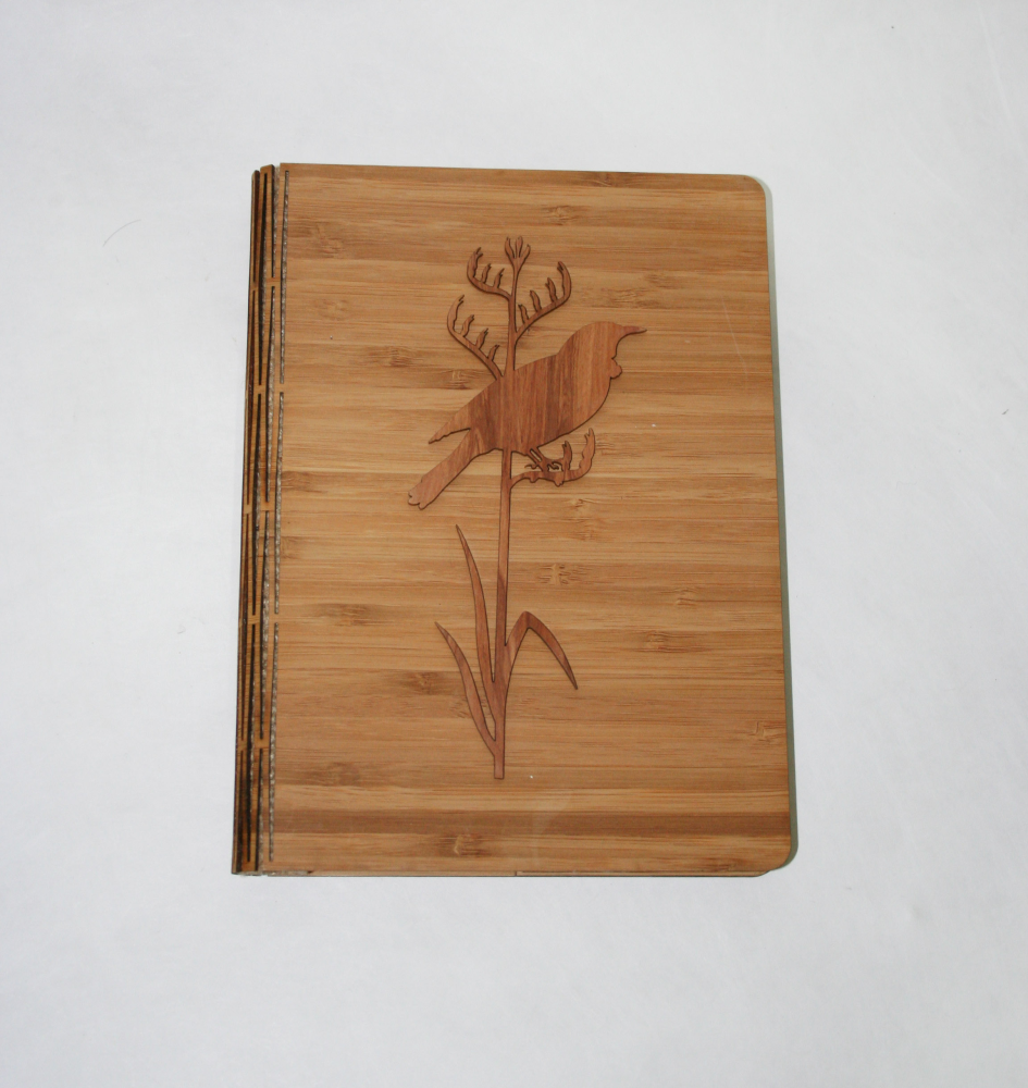 Notebook featuring Tui on Tall Flax design, crafted from NZ Silver Beech and bamboo veneer, perfect for journaling.