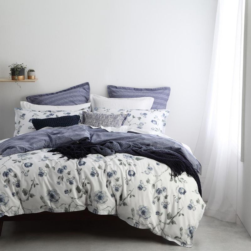 Double duvet cover set featuring rambling roses in slate blue and green on a white background, enhancing bedroom elegance.