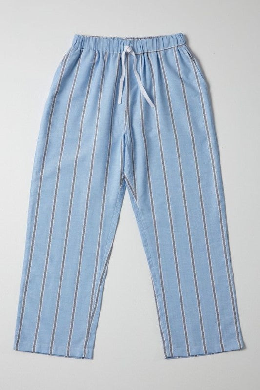 Light blue pajama pants with dark blue stripes and white borders, featuring an elastic waistband and pockets, by BAKSANA.