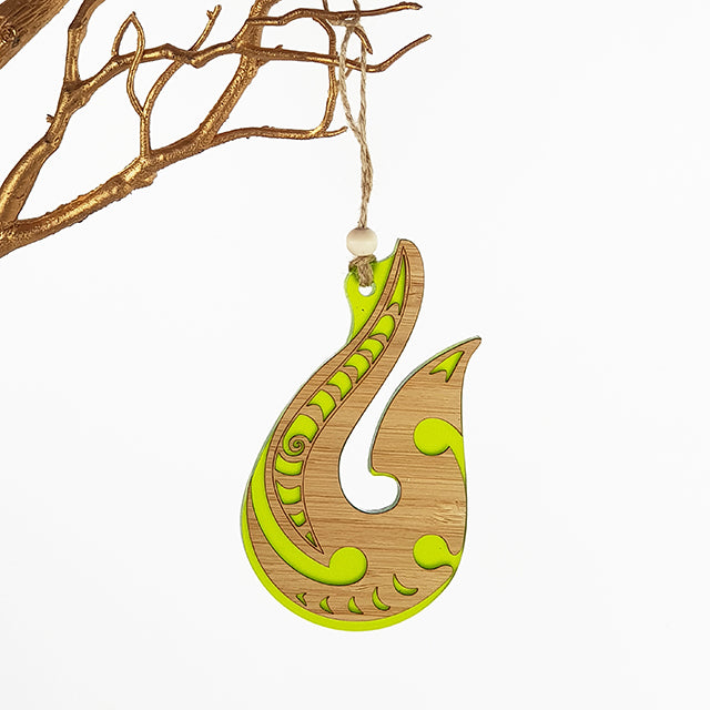 Lime green satin acrylic hanging ornament with intricate laser-cut designs, perfect for home decor or gifting.