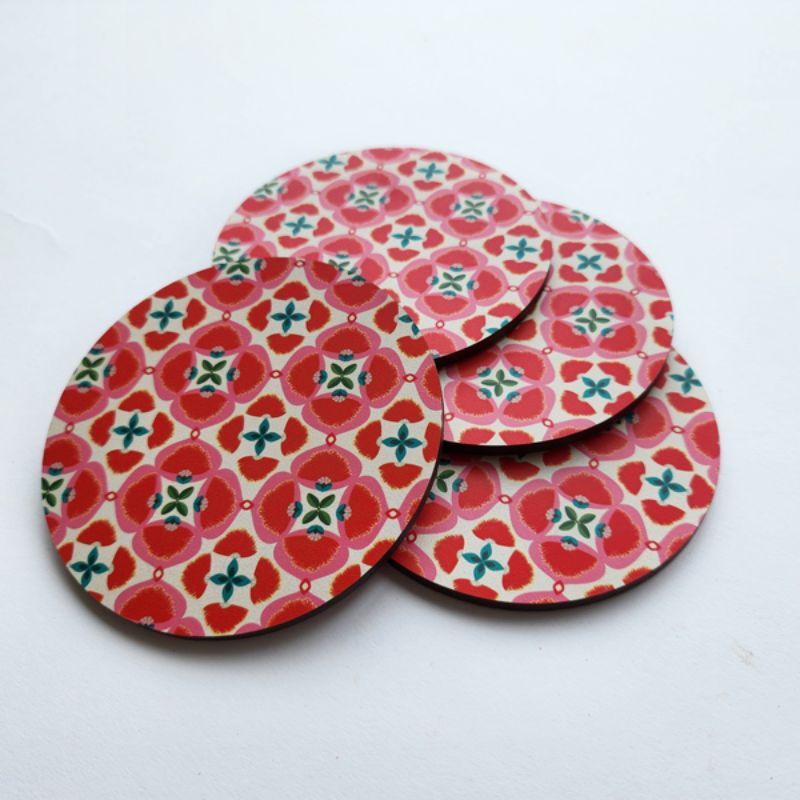 Vibrant 10cm Pohutukawa coaster with cork base, perfect for protecting surfaces in style.