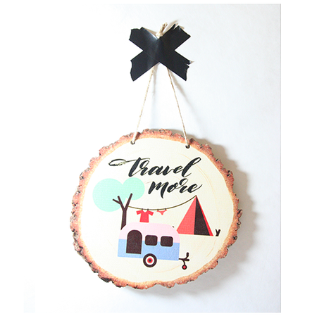 Eco-friendly wood slice wall art featuring 'Travel More' quote, inspiring adventure in any space.