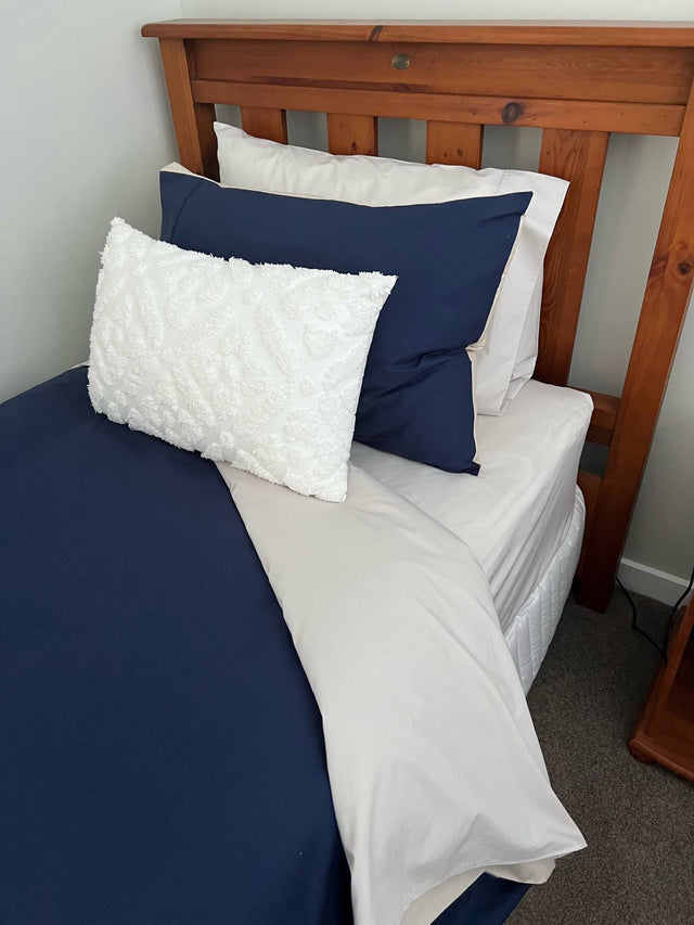 Stylish navy and silver reversible duvet cover set for single beds, crafted from 250 thread count polycotton blend.