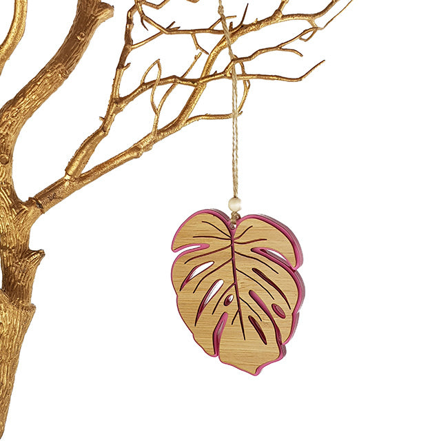 Pink satin Monstera hanging ornament, 104mm, laser-cut bamboo, adds tropical elegance to any decor.