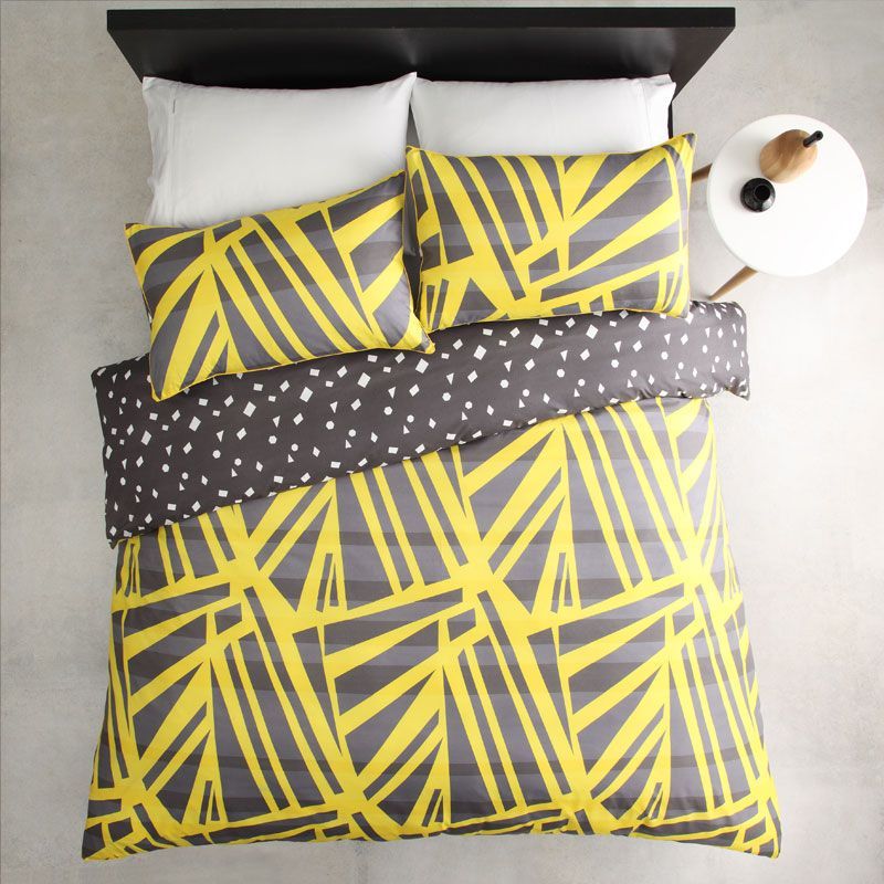 Single duvet cover set in spliced yellow with matching pillowcase, featuring a reversible print and yellow cord piping.