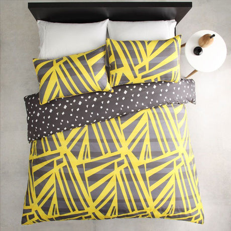 Single duvet cover set in spliced yellow with matching pillowcase, featuring a reversible print and yellow cord piping.