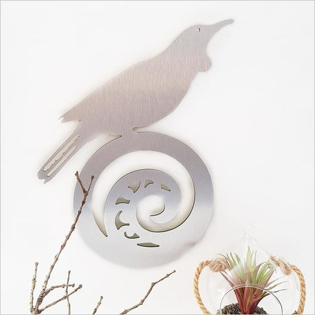 Kiwiana Wall Art featuring a vibrant tui on a koru in brushed silver, perfect for enhancing indoor or outdoor decor.