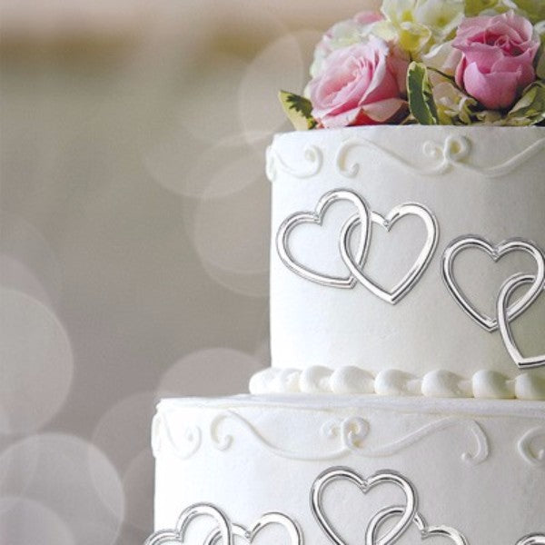 Pack of 12 silver heart-shaped cake topper picks, perfect for elevating celebrations and adding elegance to desserts.