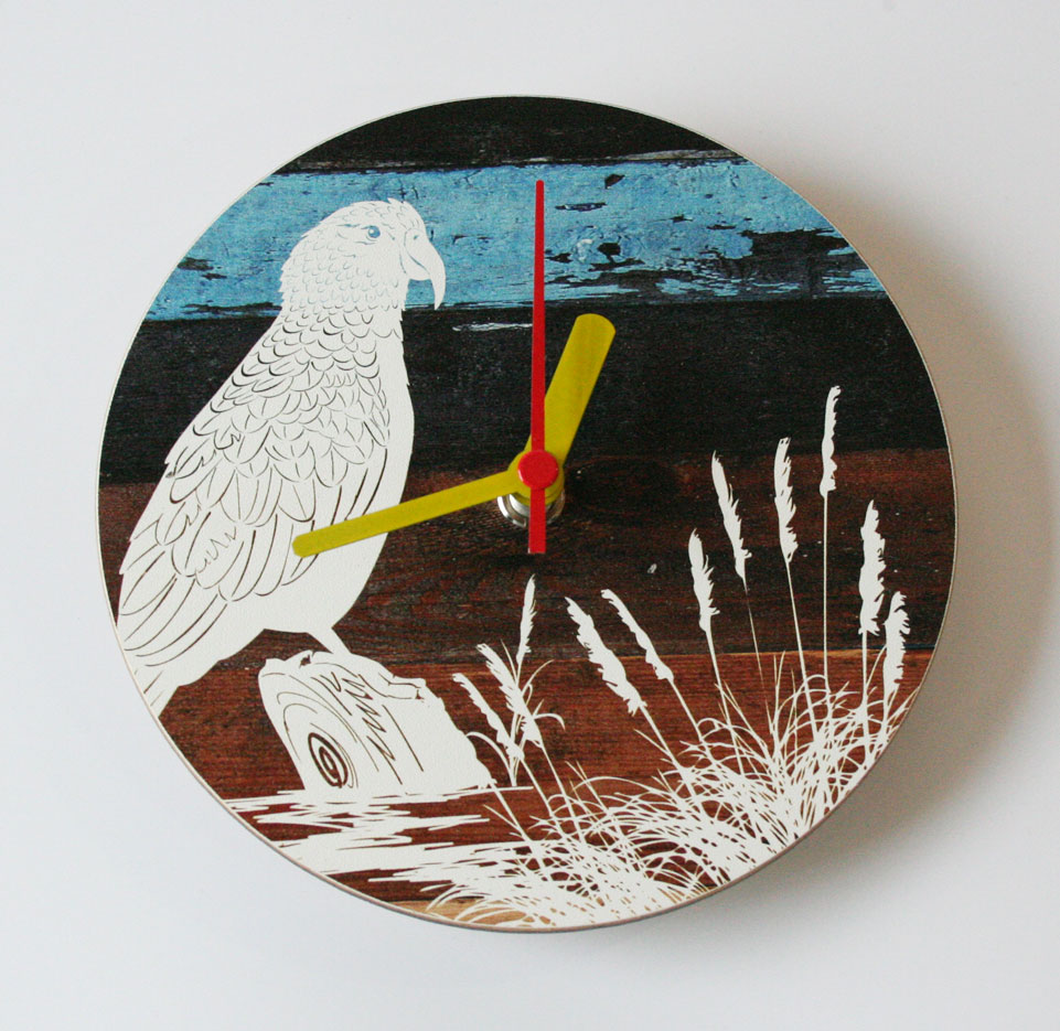 Aged Timber Kea Wall Clock featuring a vibrant Kea bird illustration, perfect for adding charm to any indoor space.