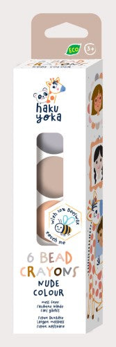 Eco-friendly Haku Yoka crayons in six nude shades, made with 10% beeswax for smooth, vibrant coloring.