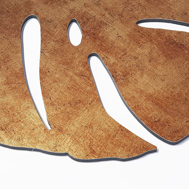 Antique gold textured monstera leaf wall art set; features three intricately designed leaves for versatile display options.