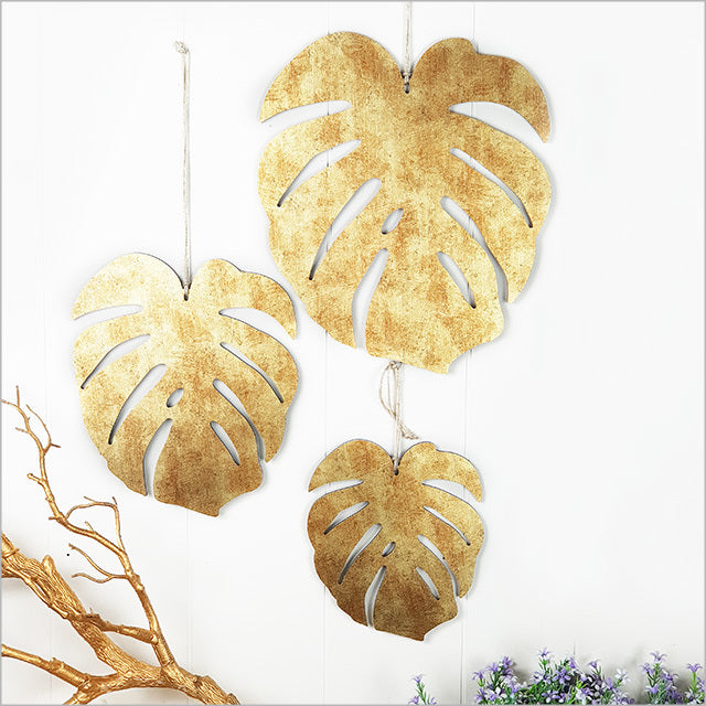 Antique gold textured Monstera wall art set featuring three intricately designed leaves, perfect for modern and bohemian decor.