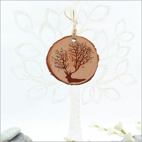 Rustic wood slice ornament featuring a deer design, ideal for Christmas decor and thoughtful gifting.
