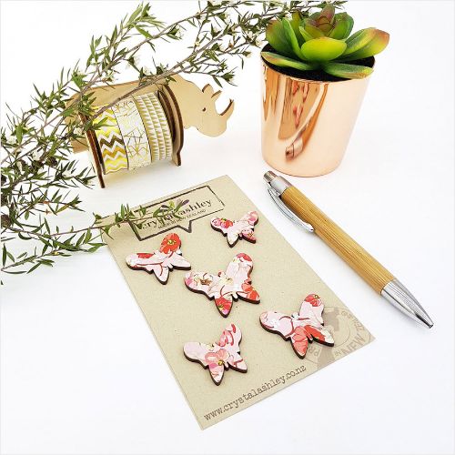 Set of 5 pink floral butterfly wall art pieces crafted from MDF, perfect for nurseries or playful interior decor.