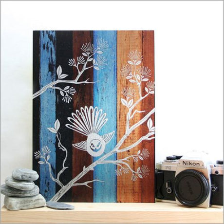 Aged timber wall art featuring a New Zealand fantail, combining tradition and modern design for versatile decor.