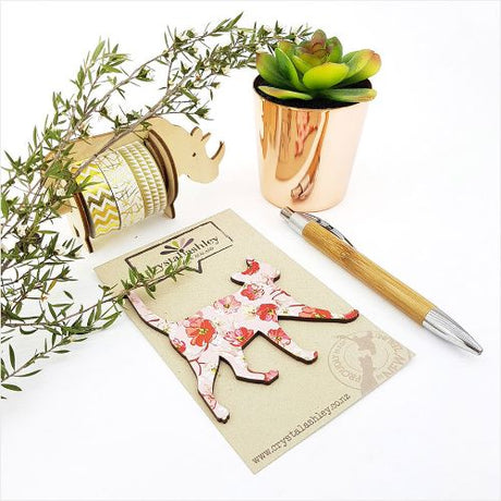 Charming wall art featuring a cat design on a pink floral background, perfect for adding whimsy to any room.