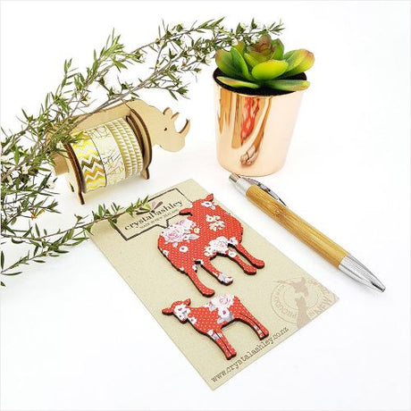 Charming wall art featuring a sheep family with red floral designs, perfect for adding whimsy to any room.