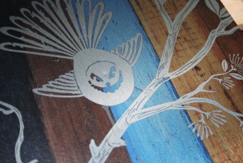Large Kiwiana wall art featuring a fantail bird illustration on rustic aged timber background, size 288mm x 420mm.