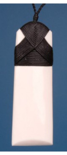 Large Plain Toki Pendant handcrafted from bone, symbolizing strength, presented in a flax kete with unique color variations.