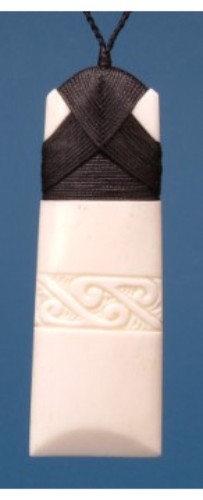 Engraved large Toki pendant in bone, symbolizing strength, measuring 92mm, on adjustable black cord.