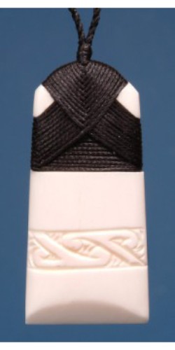 Small engraved Toki pendant in bone, symbolizing Maori strength, on adjustable black wax cord.